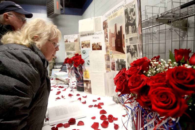Nancy Johnson of Wonder Lake and her husband Dan view mementos as a remembrance was held Saturday at Wonder Lake Fire Protection District Station 2 on the 40th anniversary of a midair military jet explosion that happened over the small, rural area northeast of Woodstock.
