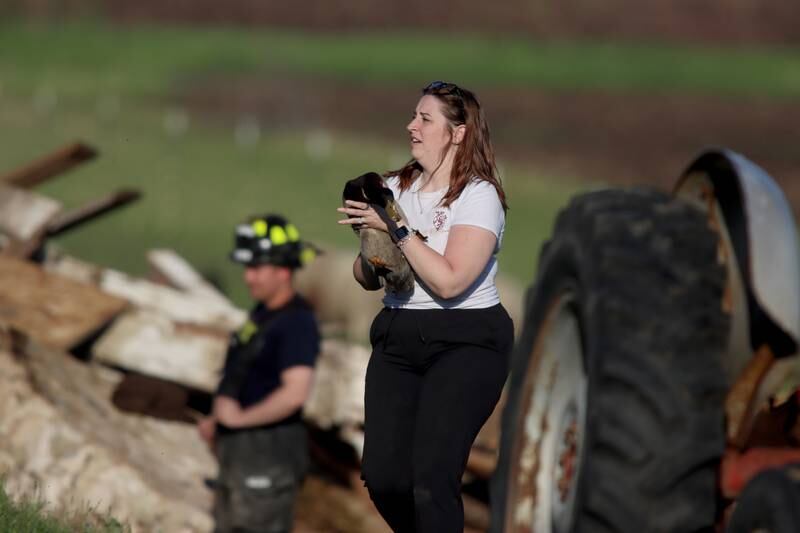 First responders and property owners tend the scene of a barn collapse along Weidner Road near Harvard on Tuesday evening.