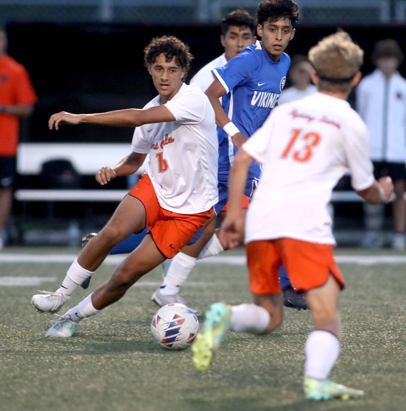 St. Charles East’s Brandon Pinto (far left) goes after the ball during a game at Geneva on Tuesday, Oct. 3, 2023.