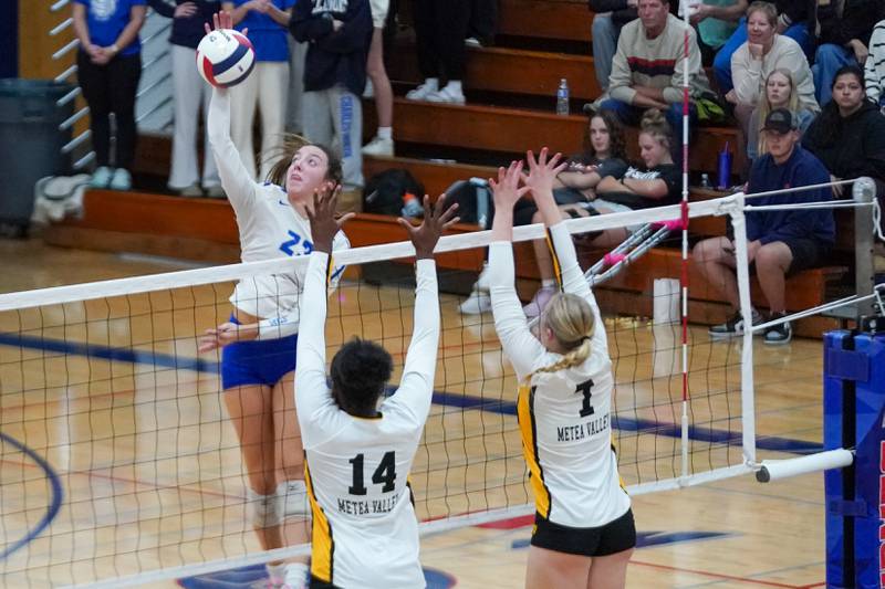 St. Charles North's Haley Burgdorf (23) goes up for a kill attempt against Metea Valley's Cheliyah Mattox (14) and Katie Schuele (7) during a Class 4A West Aurora Sectional semifinal volleyball match at West Aurora High School on Tuesday, Nov. 5, 2024.