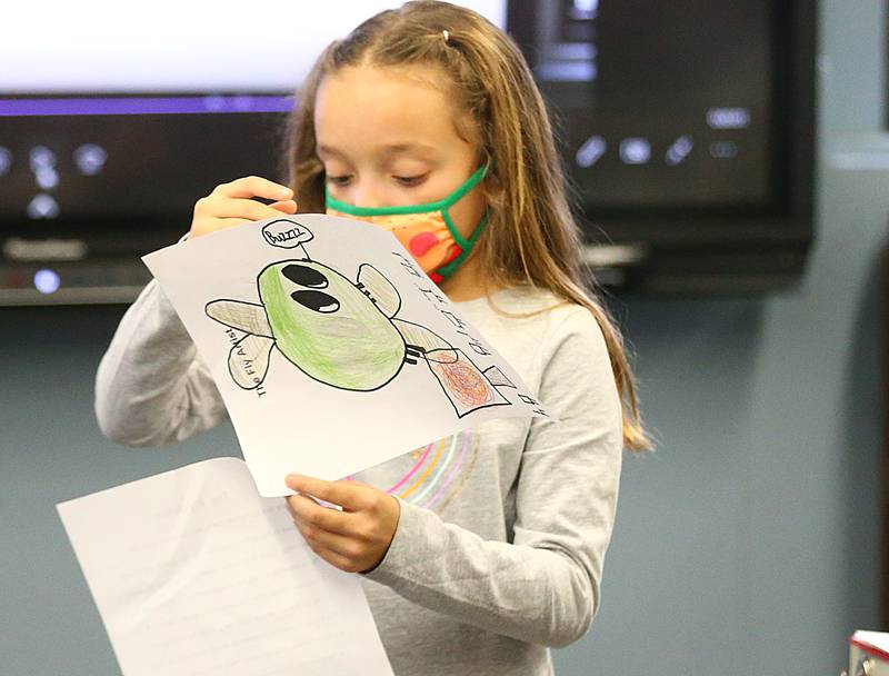 Kaelyn Manrriquez, a third-grader at Dalzell Grade School, reads her story that she wrote about "Fred the Fly"