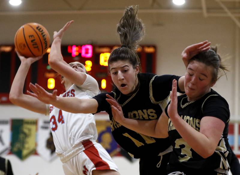 Marian Central's Juliette Huff (right) shoots the ball as Rockford Christian's Lucy Gargani (center) and Jaden Conerly (right)collide after they tried to block Huff’s shot.  during a nononference basketball game on Monday, Feb. 10, 2025, at Marian Central High School  in Woodstock.
