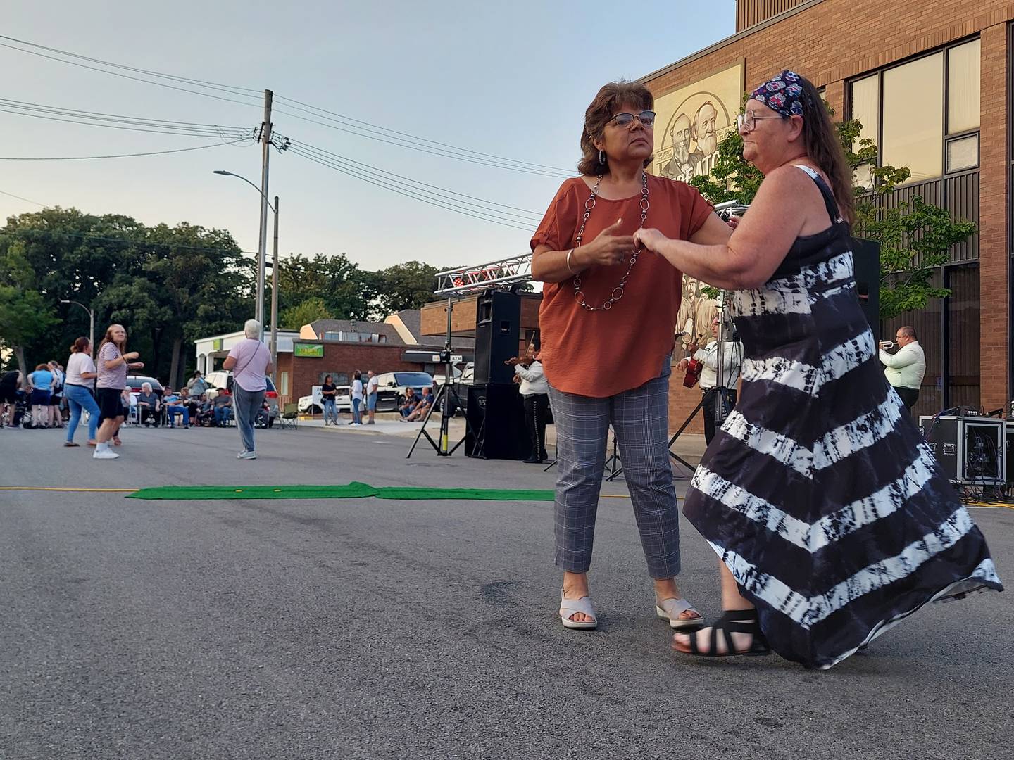 Dancers hit the streets Friday, July 26, 2024, during the Jammin' at the Clock performance of Tecalitan y Nora on Monroe Street at Heritage Park in Streator.
