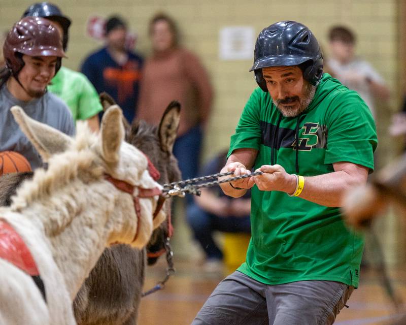 Seneca staff member Cory Yandell tugs on reigns of Donkey to get down court during game of Donkey Basketball on Saturday, Feb. 7, 2026 at Seneca High School West Campus in Seneca.