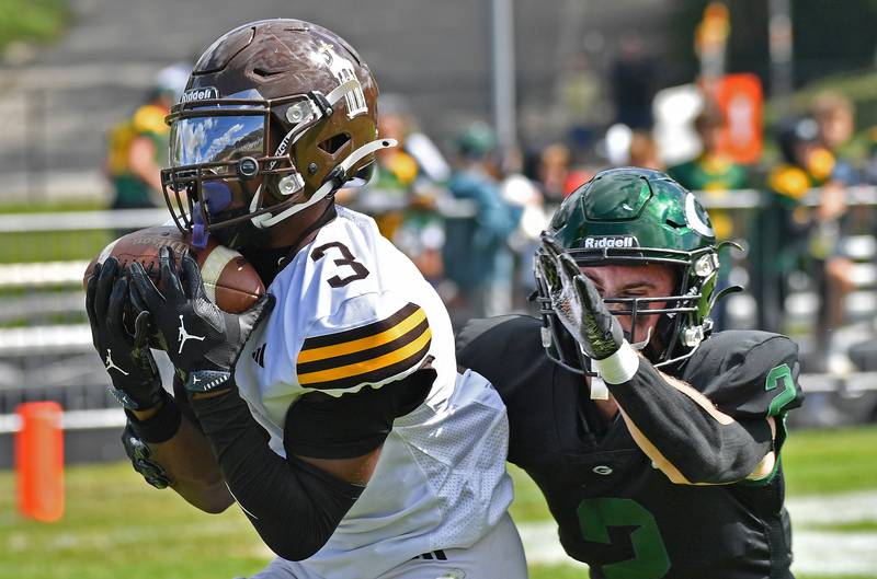 Joliet Catholic’s Jayden Armstrong (3) makes his second touchdown catch of the game in front of Glenbard West’s Jack Davis during a game on September 6, 2025 at Glenbard West High School in Glen Ellyn.