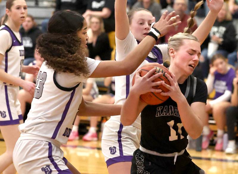 Kaneland's Berlyn Ruh is surrounded by Dixon’s Ahmyrie McGowan (left) and Katie Drew Thursday, Feb. 22, 2024, during their Class 3A sectional final game at Sycamore High School.