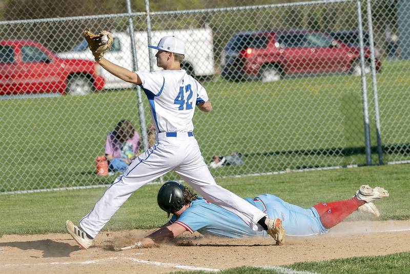 Hall’s Payton Dye slides in safe at home as Newman’s Chase Decker covers on a wild pitch Monday, April 15, 2024 at Newman High School.