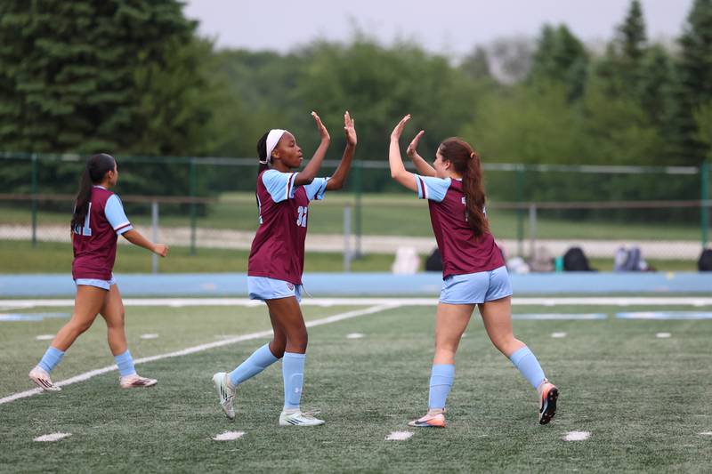 Kankakee's Alina Mkhwanazi, left, is high-fived after a goal by teammate Vanessa Arellano during the Kays' 5-0 win against Blue Island Eisenhower in the Class 2A Kankakee Regional semifinals on Tuesday, May 19, 2026.
