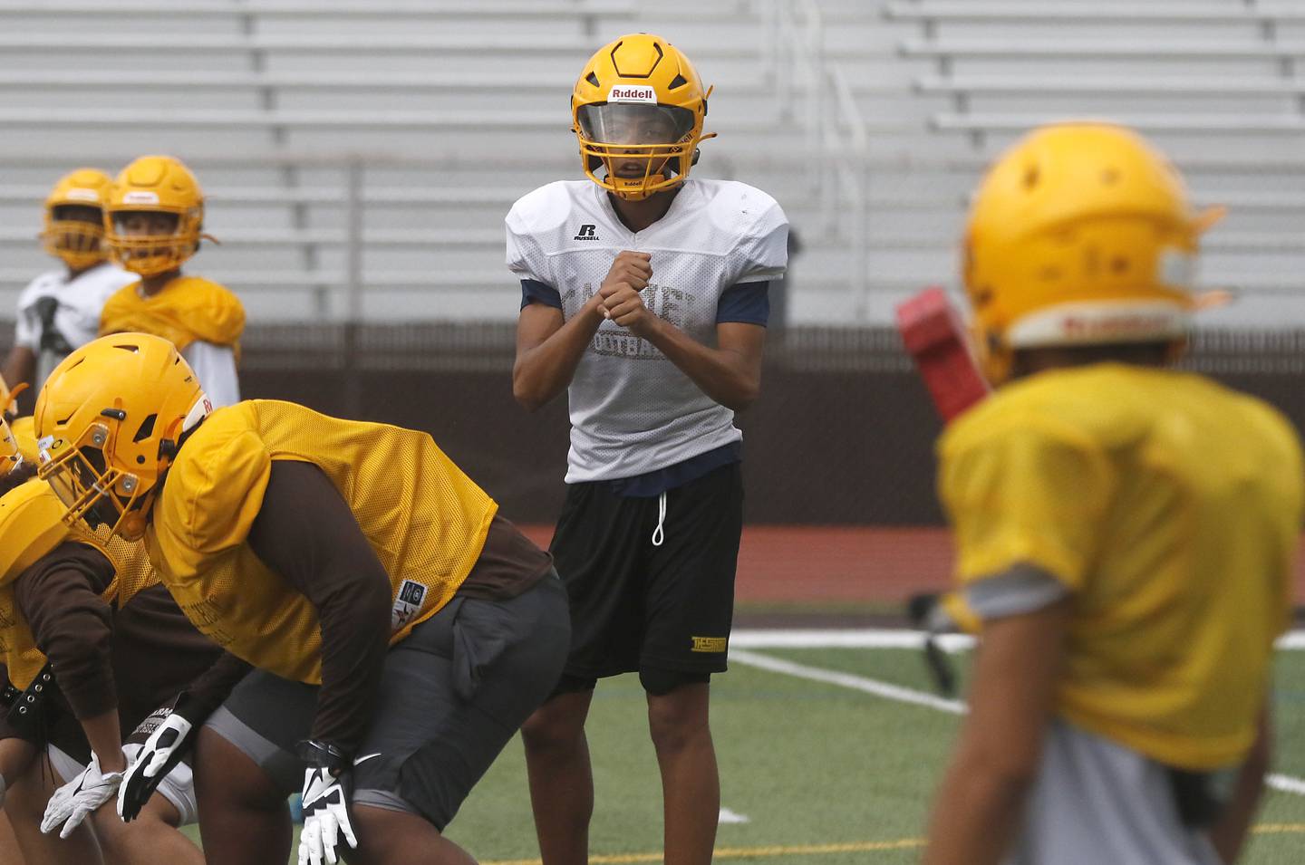 Carmel Catholic High School freshman quarterback Trae Taylor, a Crystal Lake resident, signals a receiver during practice Monday Aug. 14, 2023, at the school in Mundelein.