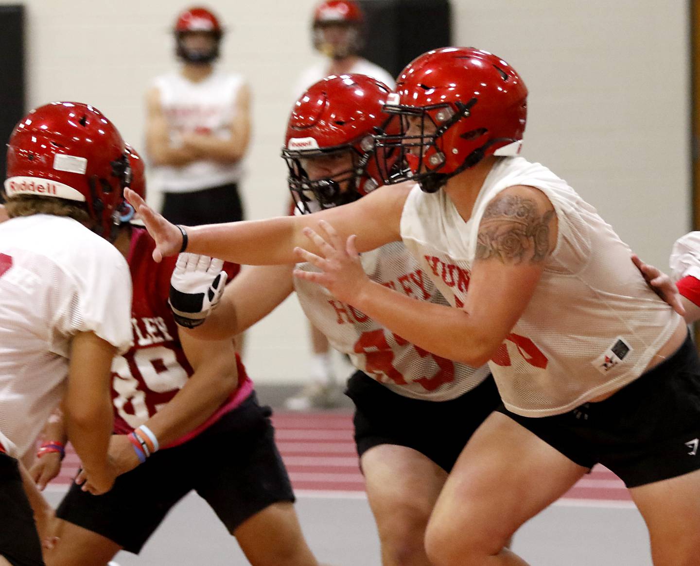 Huntley’s Luke Griskey blocks during the first day of football practice Monday, 8, 2022, in the Huntley High School  field house after stormy weather move practice inside.