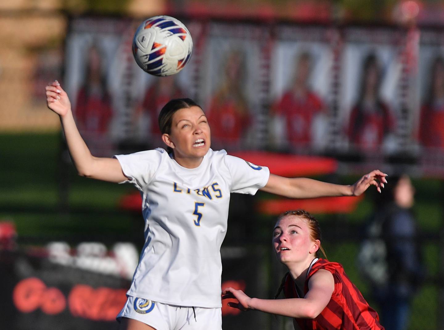 Lyons Township’s Quinn Conway heads the ball as Hinsdale Central’s Addisyn Krogstie defends during a game on April 29, 2025 at Hinsdale Central High School in Hinsdale.