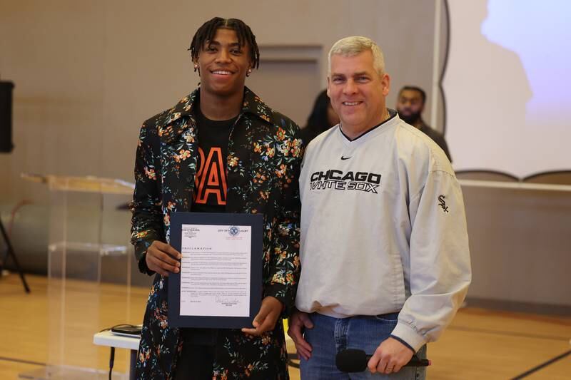 Joliet Mayor Bob O’Dekirk (right) presents a proclamation to Jeremy Fears Jr. Friends and family host a reception for Joliet West’s basketball player Jeremy Fears Jr. before he heads to Houston to play in the All-McDonalds game.