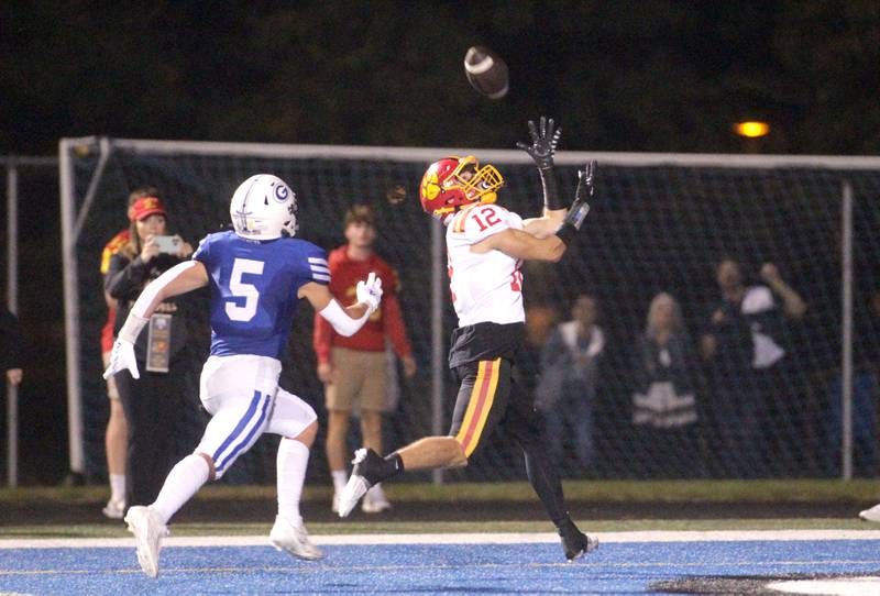 Batavia’s Luke Alwin makes a catch in the end zone for a touchdown away from Geneva’s Dylan Reyes during a game at Geneva on Friday, Sept. 29, 2023.
