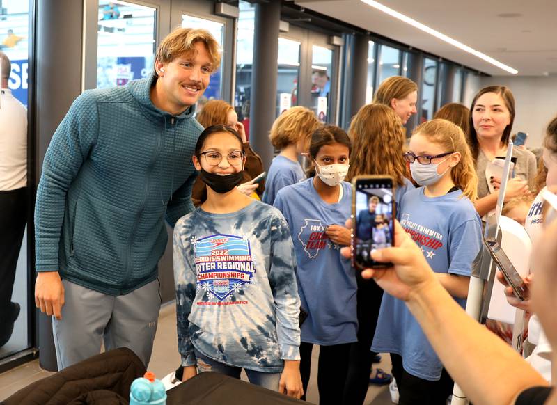 Olympic swimmer Caeleb Dressel (left) poses for photos during the Tyr Pro Swim Series Westmont at the FMC Natatorium in Westmont Thursday, March 3, 2022. The meet continues through Saturday.