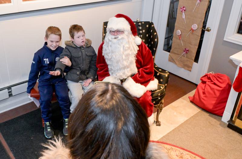 Duncan and Harrison La Gesse of South Elgin have their photo taken as they visit Santa at the Geneva Visitor Center on Saturday, Dec 20, 2025 in Geneva.