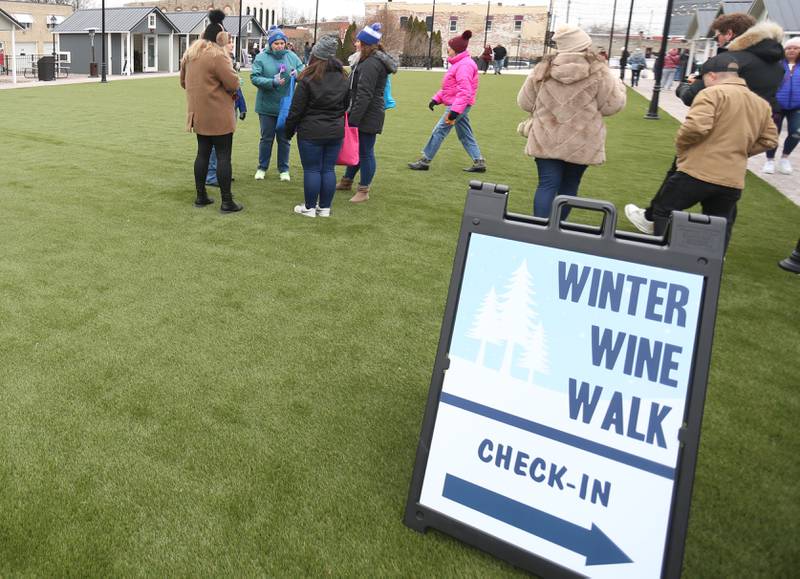 Dozens of wine enthusiasts check in during the Winter Wine Walk on Saturday, Feb. 8, 2025 at the Market on Mill plaza in Utica.