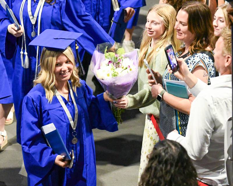 A St. Charles North graduate gets flowers during the graduation ceremony on Monday, May 18, 2026, held at the Convocation Center in DeKalb.