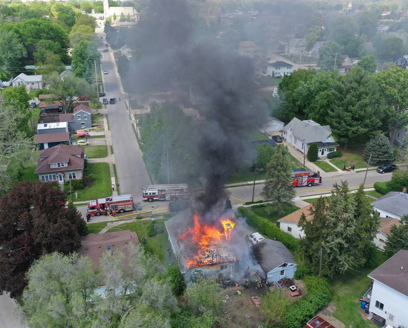 An aerial view of structure fire as flames pour out of the roof in the 1900 block of Main Street on Monday, May 4, 2026 in Peru.