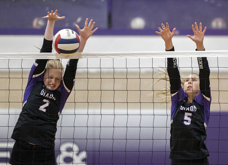 Dixon’s Madyson Tichler (left) and Morgan Hargrave blocks a shot against North Boone Tuesday, Sept. 24, 2024, in Dixon.