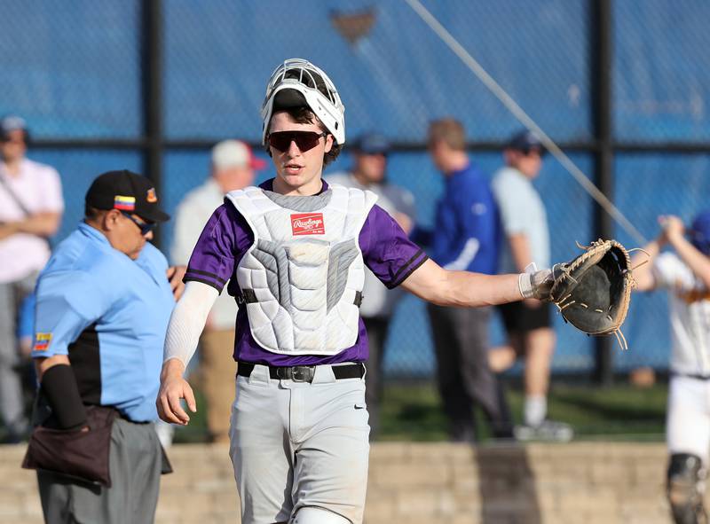 Downers Grove North's Jimmy Janicki (16) talks to the coaches in the dugout during the boys varsity baseball game between Lyons Township and Downers Grove North high schools in Western Springs on Tuesday, April 11, 2023.