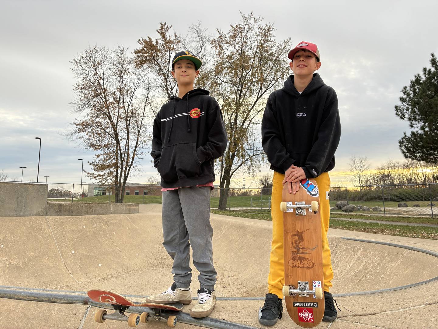 Sid Fox, 12, right, and Noah Gere, 13, on Monday, Nov. 17, 2025, at McHenry's Ryan Bus Zone Skate Park. The friends are designing and selling skateboard decks locally.