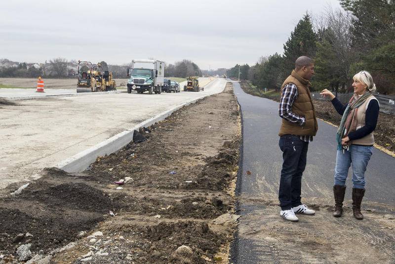 William Hicks (left) of Algonquin and Jo Ann Fritz, a former Dundee resident, talk near the intersection of Longmeadow Parkway and Sleepy Hollow Road on Friday in Algonquin. Plans for the controversial project call for a four-lane, 5.6-mile east-west corridor connecting Randall Road with Route 62. The project was supposed to be complete by Nov. 15, but it won't be done until mid-December.