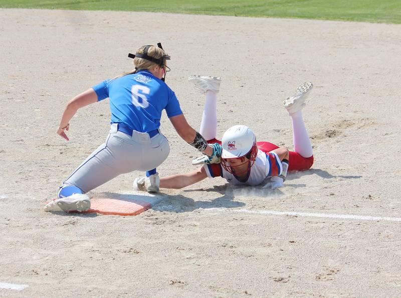 Newman first baseman Sam Ackman tries to tag out a Morrison baserunner Saturday during the Class 1A Newman Regional championship in Sterling.