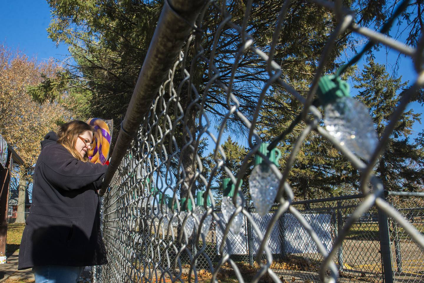 Janel Stahr of Stahr Media hangs lights on a fence at Centennial Park in Rock Falls for the second annual holiday light display. Local organizations could decorate from Tuesday to Thursday with opening night taking place Friday, Dec. 3.