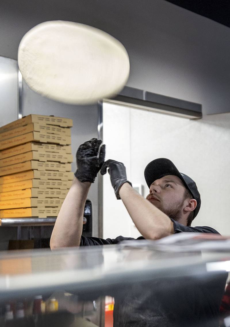 The dough at Artisan Oven is hand tossed as seen Thursday, March 19, 2026.