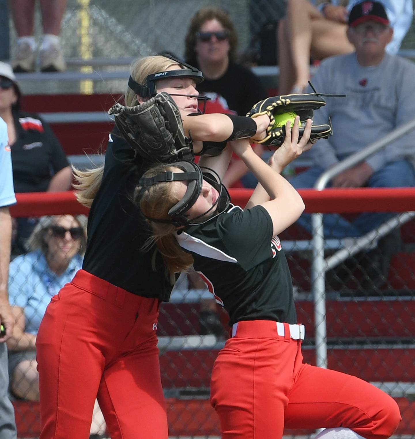 Forreston firstbaseman Ella Ingram and second baseman Alaina Miller go for a fly ball during the game for third place at the 1A state softball finals in Peoria on Saturday. The Cardinals beat Newark 4-2 in 8 innings.