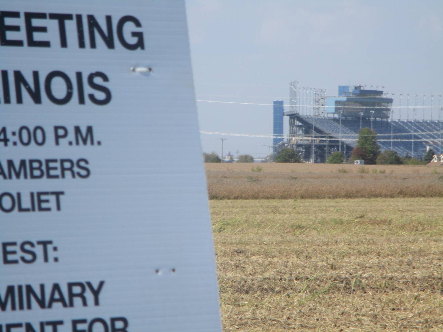 The Chicagoland Speedway can be seen in the background of a sign on Ridge Road posting notice of an Oct. 16 meeting of the Joliet Plan Commission on plans for a data center on land that would be annexed into Joliet. Oct. 3, 2025