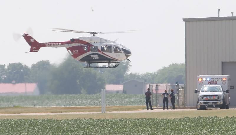 Peru EMS personnel watch OSF Lifeflight helicopter take off with a patient who was transfered to the OSF Lifeflight base at the Illinois Valley Regional Airport on Wednesday, June 21, 2023 in Peru. Without an emergency room at St. Margaret's, patients in critical condition are being flown from the airport to Peoria or other Level 1 trauma centers.