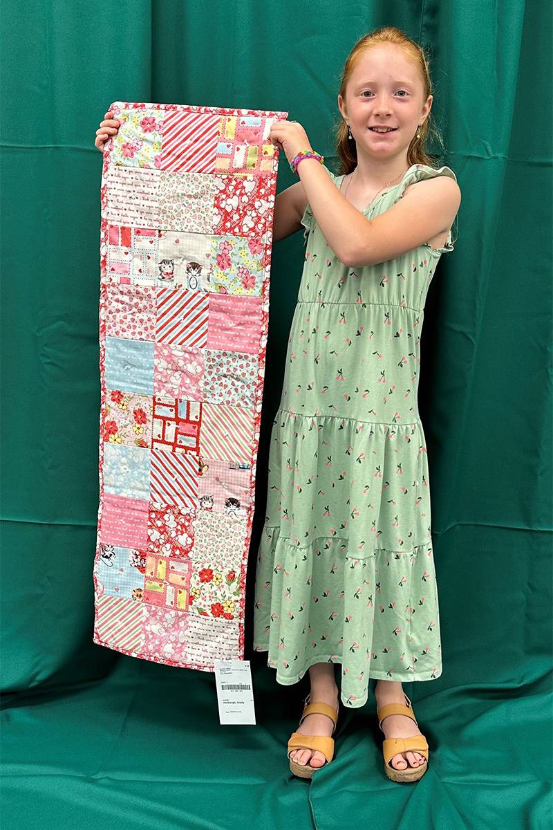 Ogle County 4-H member Emily Harbaugh holds her award-winning 4-H entry.