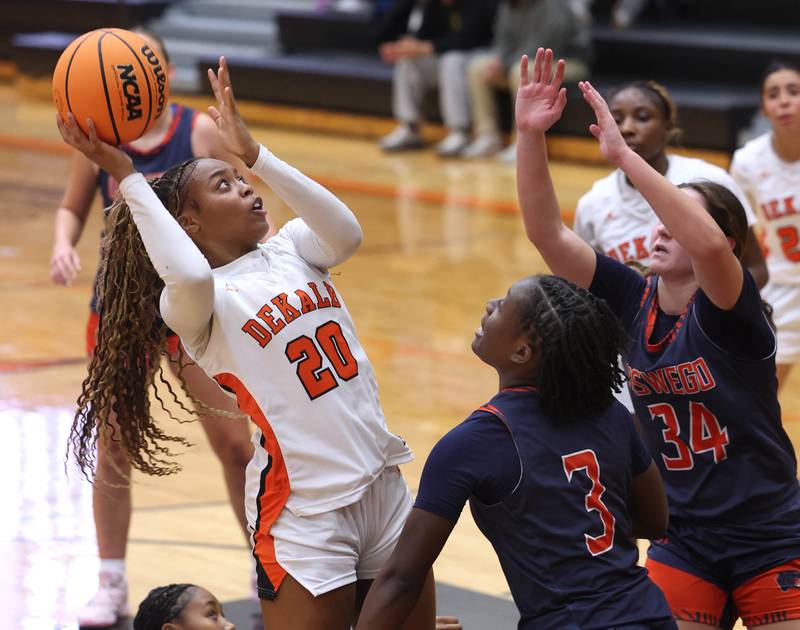 DeKalb's Zora Watts tries to shoot over Oswego's Madelyn-Jordyn Mensah during their game Monday, Jan. 5, 2026, at DeKalb High School.
