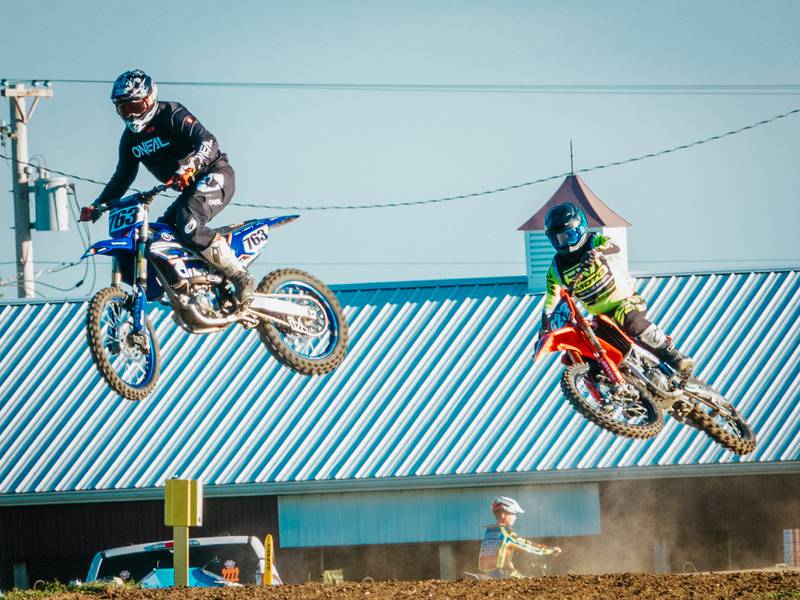 Megacross riders fly over hill in race on Saturday, August 31, 2024 at the Tri County Fair in Mendota.