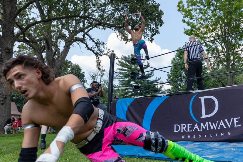 (left to right) Jordan Kross crawls away as Stephen Wolf celebrates win at the Taste of the Illinois Valley DreamWave Wrestling event on Saturday, August 2, 2025 at Centennial Park in Peru.