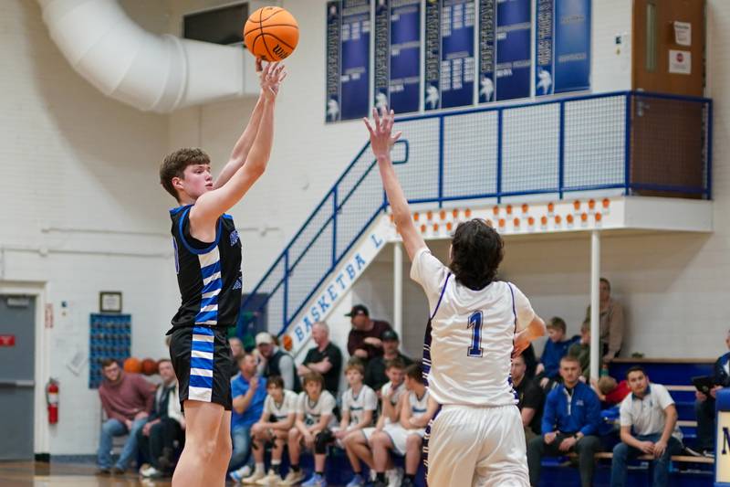Hinckley-Big Rock's Max Hintzsche (10) shoots a three pointer over Newark’s Austin Reibel (1) during a basketball game at Newark High School on Tuesday, January 28, 2025.