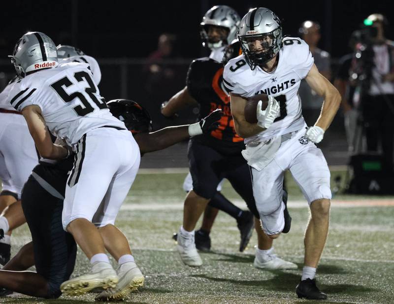 Kaneland's Carter Grabowski tries to get outside the DeKalb defense during their game Friday, Sept. 12, 2025, at DeKalb High School.