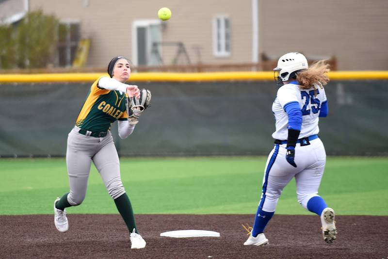 Coal City's Sierra Anderson, left, throws to first to complete a double play after forcing Peotone's Megan Cadieux out at second during a game at Coal City Wednesday, April 9, 2025.