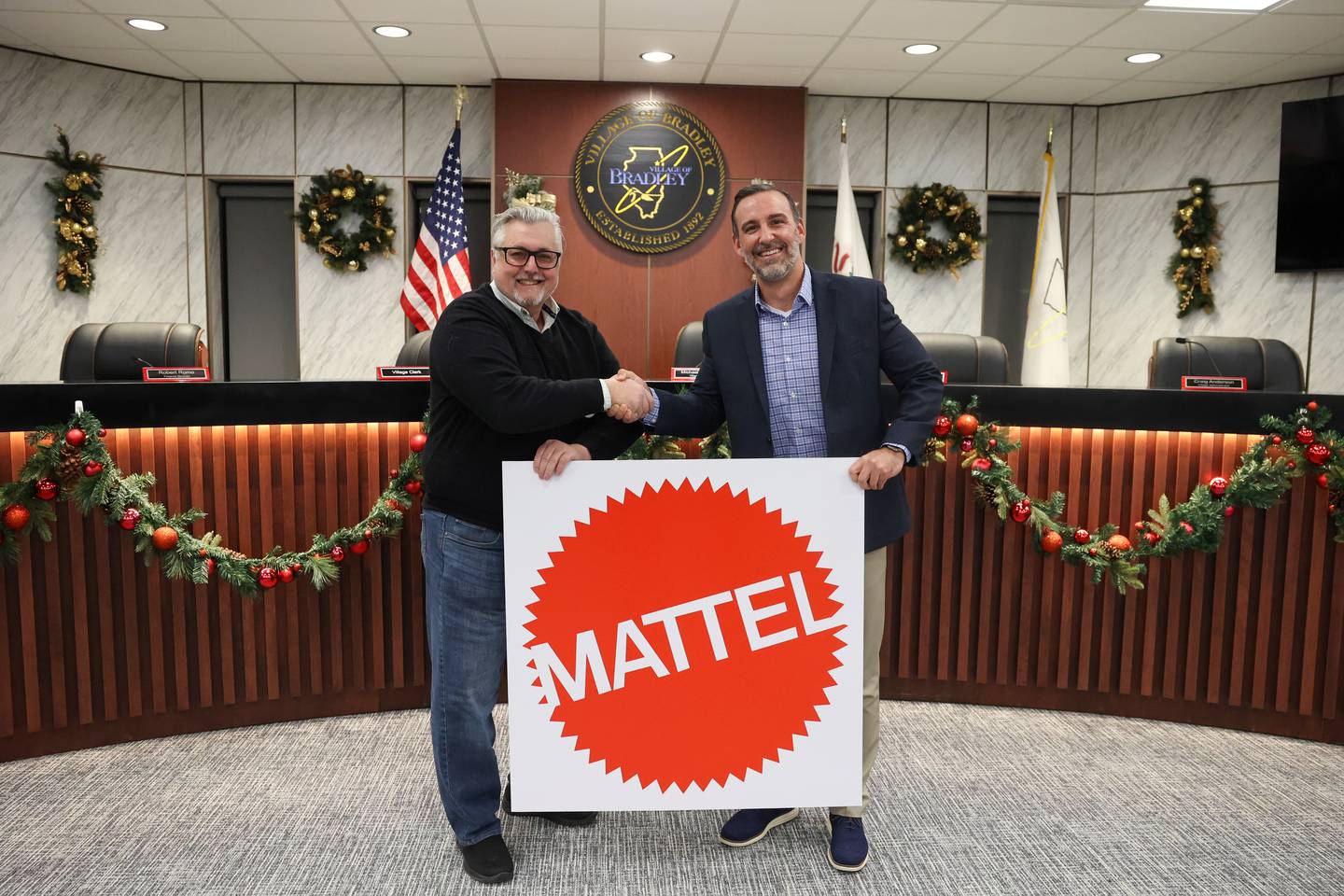 Bradley Mayor Mike Watson shakes hands with Justin Brown, right, executive vice president of development with American Resort Management, after the resolution to approve the licensing agreement for the planned waterpark passed at the village Bradley board meeting on Monday, Dec. 8, 2025. American Resort Management and Mattel have partnered to create a new brand of indoor waterparks, Mattel Wonder. Bradley's waterpark wil be one of the first sites.