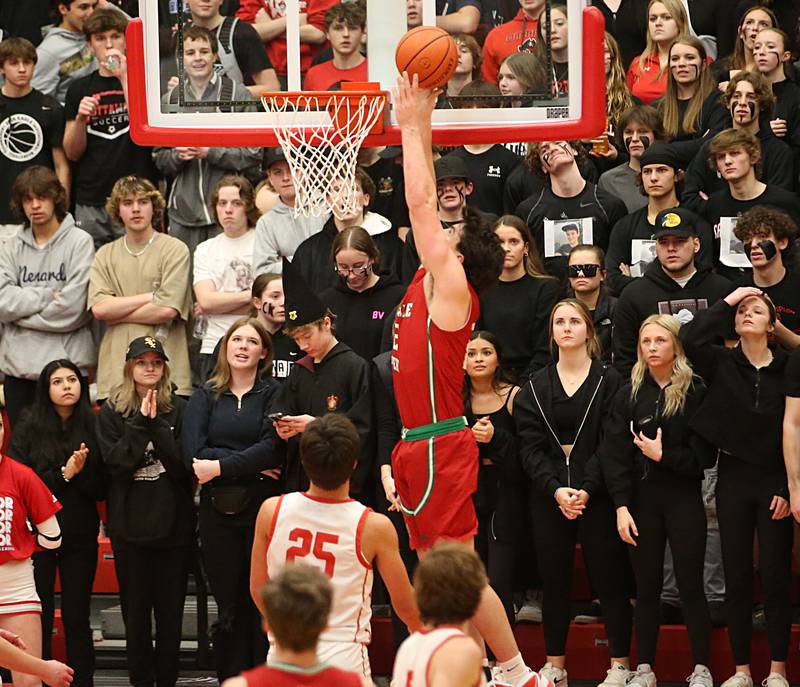 L-P's Josh Senica scores on a drive to the hoop over Ottawa's Payton Knoll in Kingman Gymnasium on Friday, Feb. 10, 2023 at Ottawa High School.