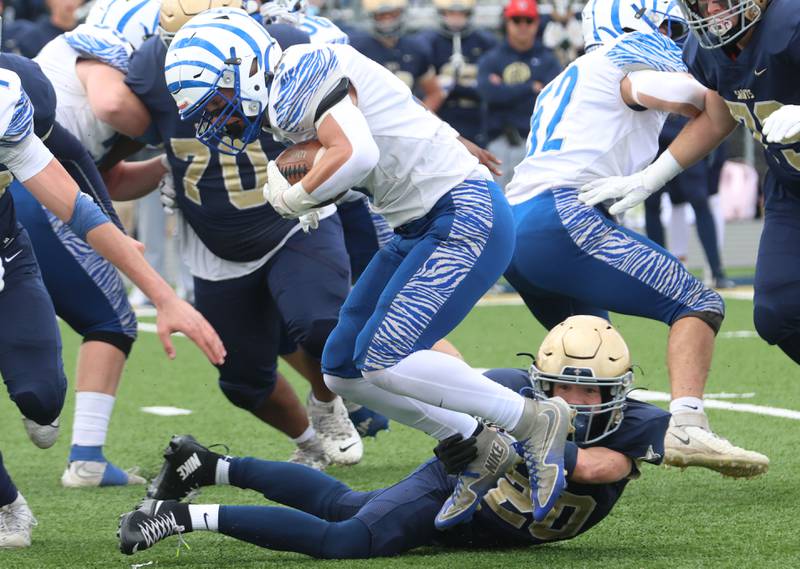Princeton's Lane Goskusky leaps over Central Catholic's Pete Hall to gain extra yards durring the Class 3A playoffs on Saturday, Nov. 1, 2025 at Central Catholic High School in Bloomington.