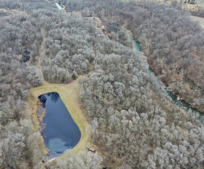 Environmental officials look at a holding pond (bottom left) where a chemical agent spilled into it just to the east of Carus Chemical next to the Little Vermilion River (right) on Thursday, Jan. 12, 2023 in La Salle.