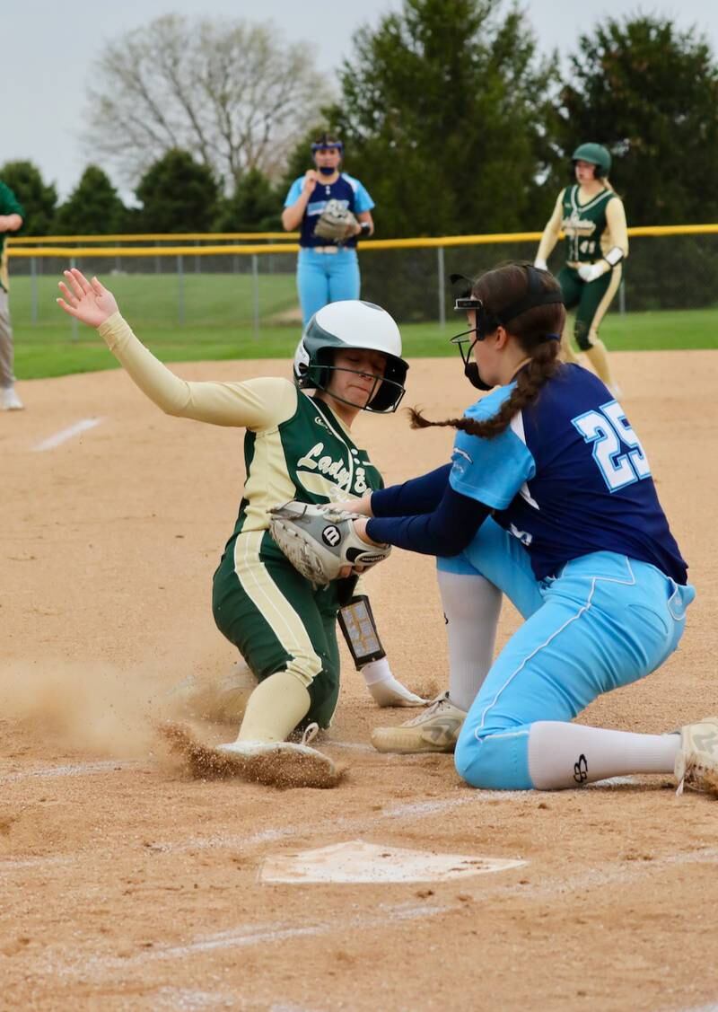 Bureau Valley pitcher Tyra Sayler puts the tag on St. Bede's Bella Pinter at the plate on a wild pitch in the first inning of Monday's game at Manlius. The visiting Bruins won 11-4.