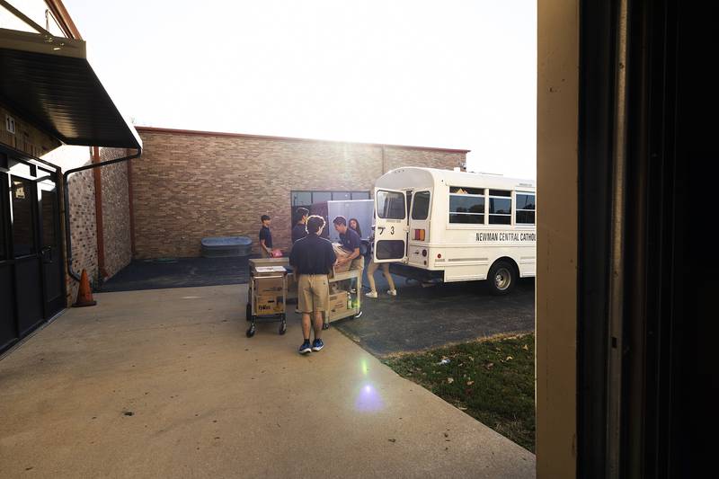 Students load the items into a bus Thursday, Oct. 3, 2024, at Newman High School. This is the 23rd year for the annual food drive.
