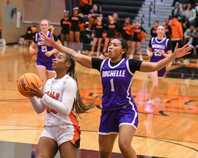 DeKalb's Zora Watts, left makes a basket while being defended by Rochelle's Carmela Bright during the game on Monday Dec. 2, 2024, held at DeKalb High School.