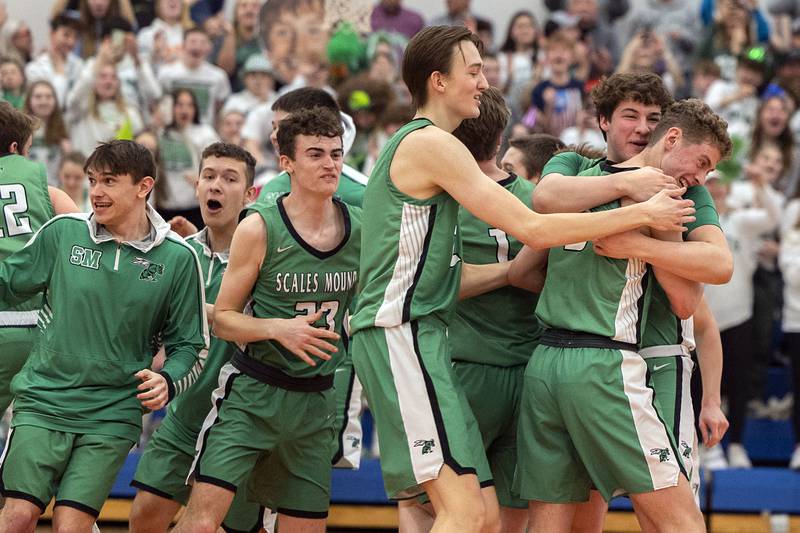 The Scales Mound Hornets celebrate a 50-46 win over the Fulton Steamers Friday, March 3, 2023 in the 1A sectional final in Lanark.