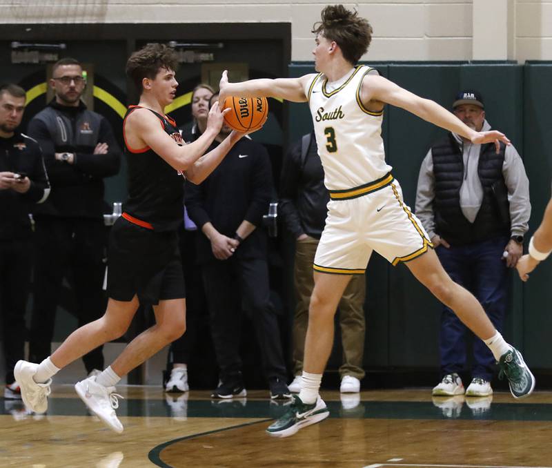 McHenry's Caleb Jett gets past the defense of Crystal Lake South's Nick Stowasser during a Fox Valley Conference basketball game on Friday, Jan. 31, 2025, at Crystal Lake South High School.