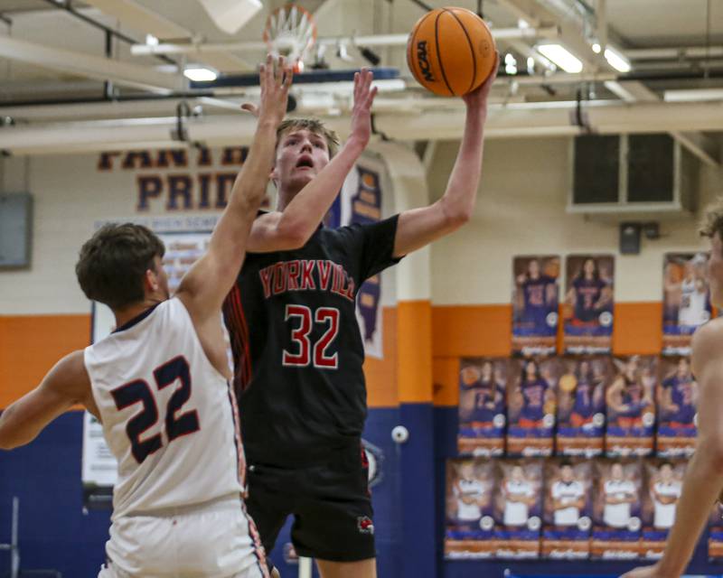 Yorkville's Joey Jakstys (32) shoots over Oswego's Luke Roller (22) during their basketball game between Yorkville at Oswego, Feb 7, 2026 in Oswego.