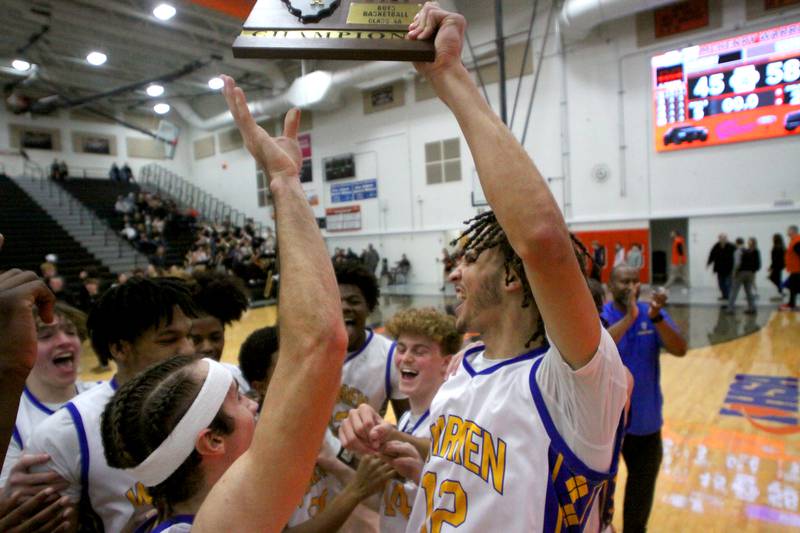 Warren’s Blue Devils celebrate a win over McHenry in IHSA Class 4A Regional Title Game boys basketball action on Friday, Feb. 28, 2025 at McHenry High School in McHenry.